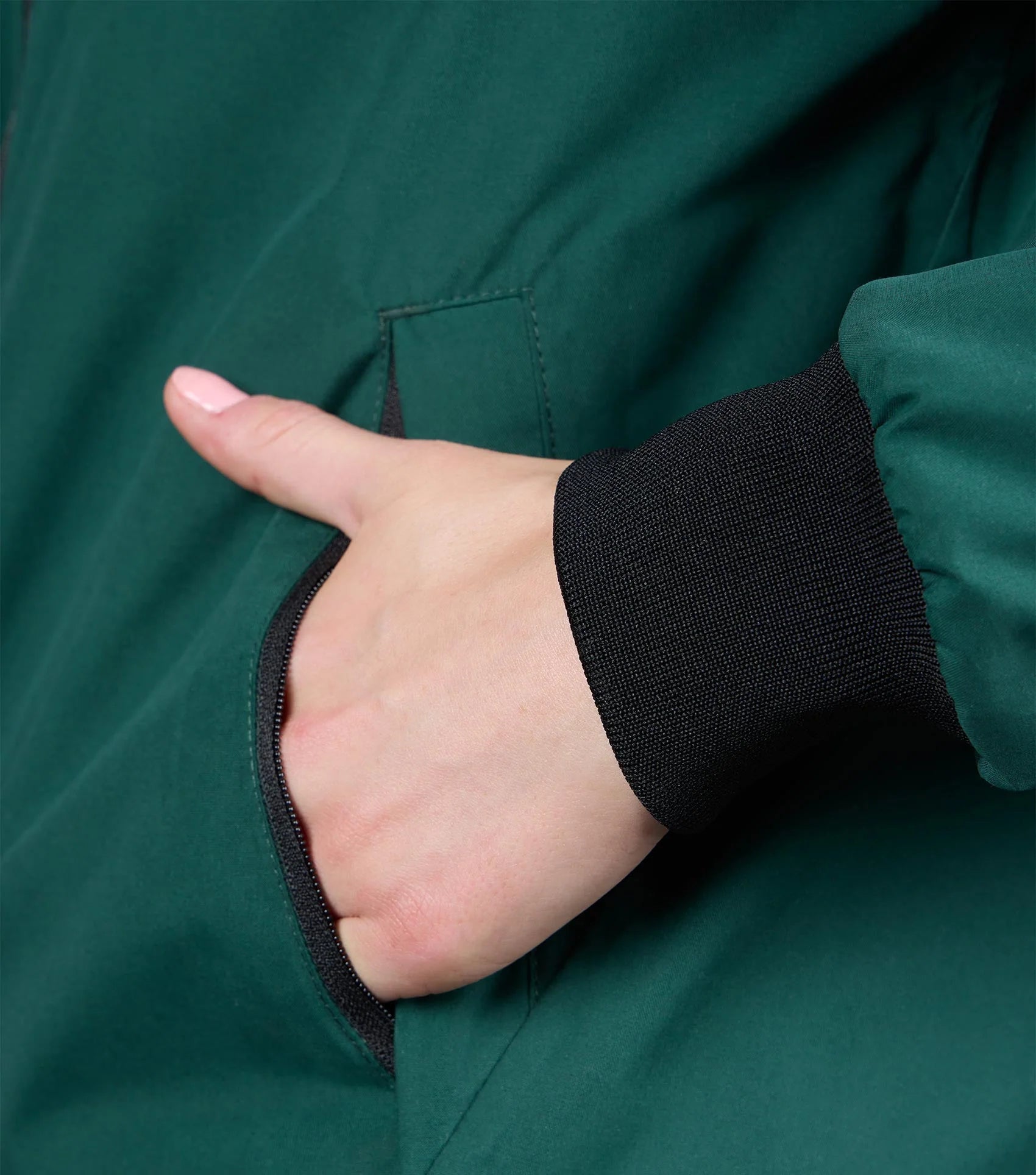 Premier Equine Omnia Women's Waterproof Riding Jacket Green. Hand in pocket, close-up view.