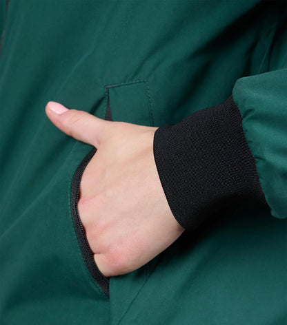 Premier Equine Omnia Women's Waterproof Riding Jacket Green. Hand in pocket, close-up view.