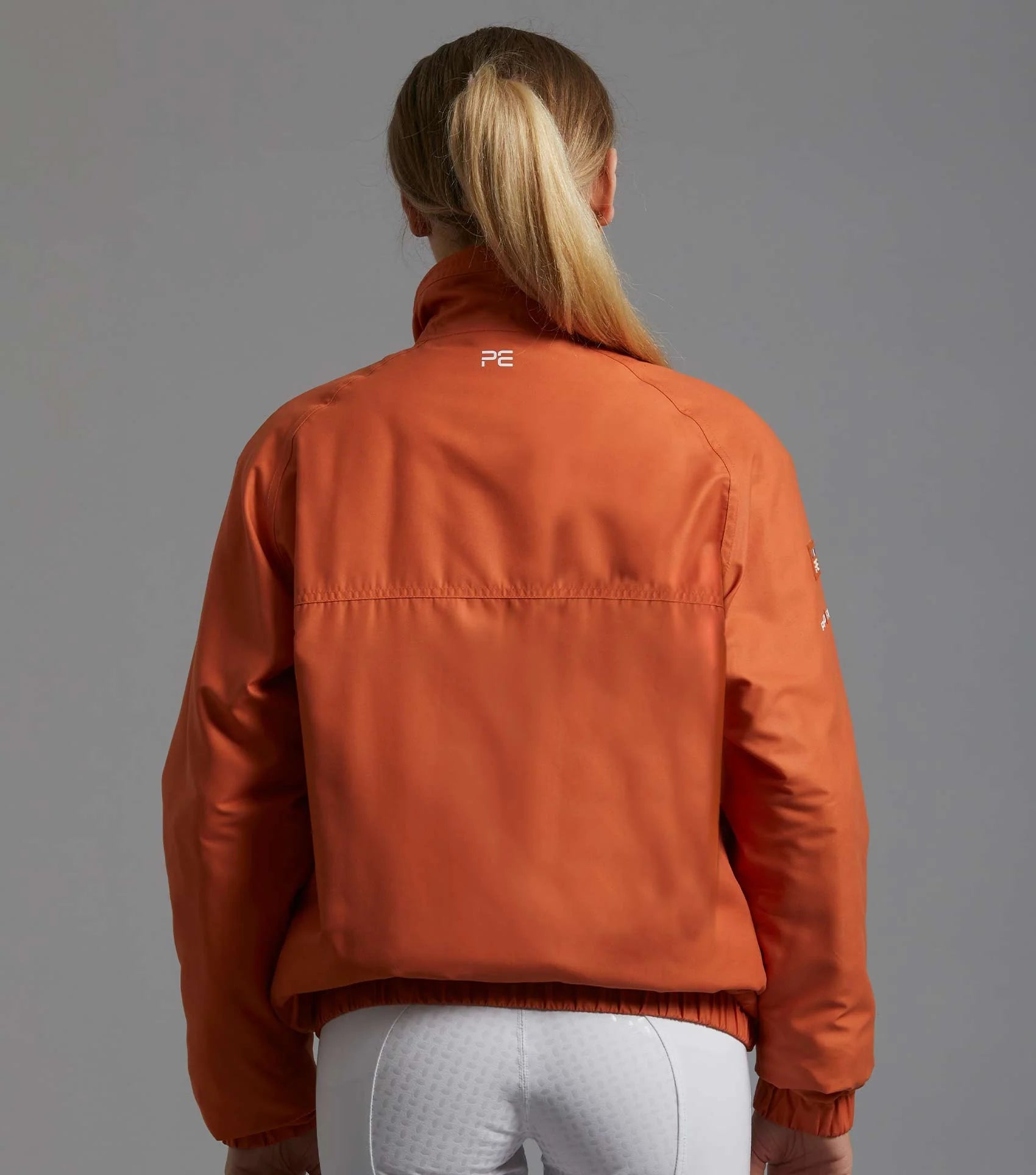 Premier Equine Pro Rider Waterproof Riding Jacket Burnt Orange. Unisex equestrian coat, horse riding apparel. Equiflair.