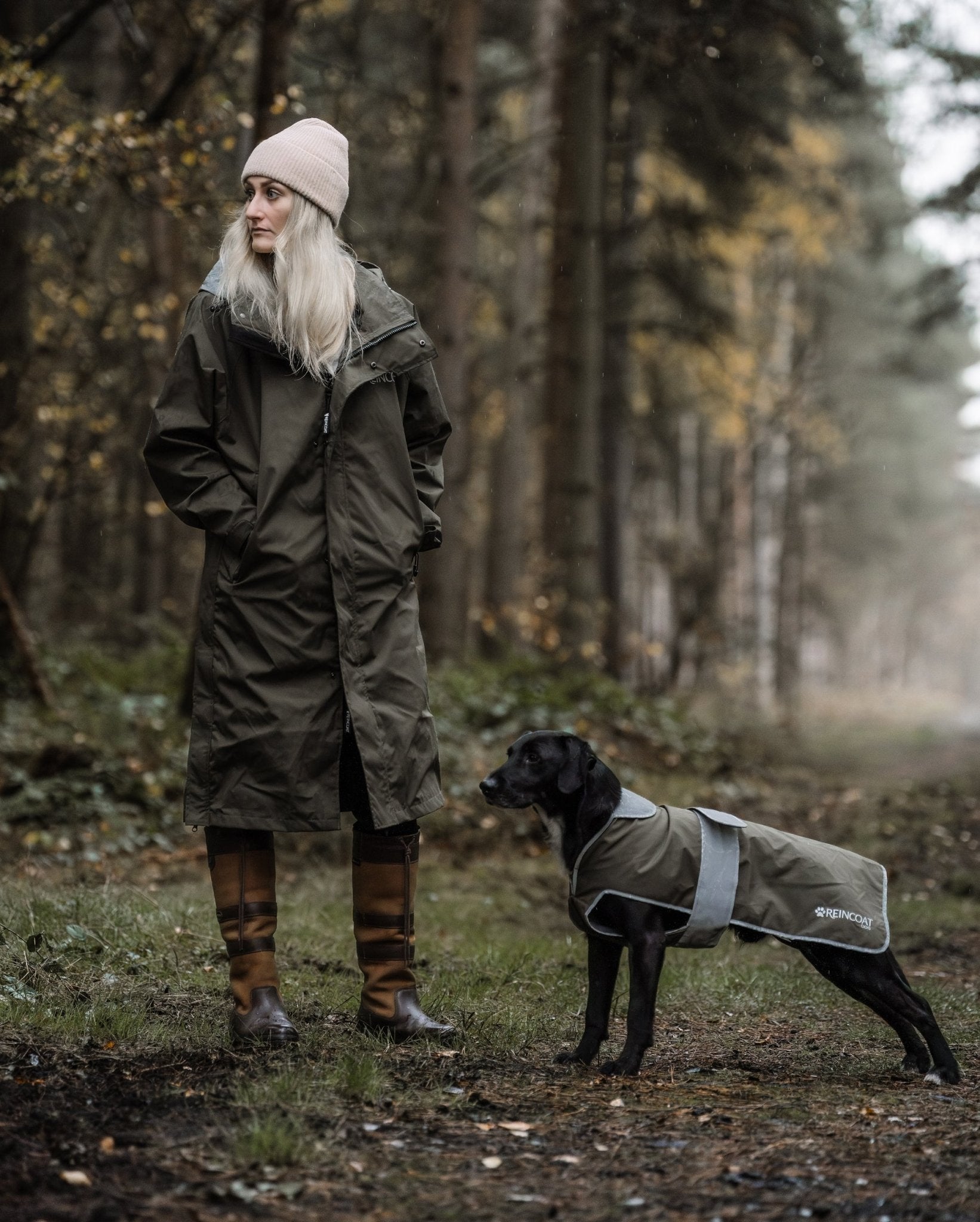 Woman & Dog in Raincoats: Waterproof REINCOAT DOG in Olive by Equiflair. Stylish, protective dog apparel in forest setting.