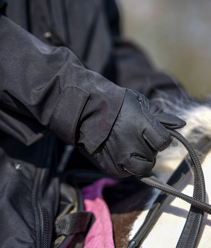 Equestrian Riding Jacket: Black Waterproof Coat - Glove holding reins. Ladies Riding Apparel for Horse Riding - Equestrian Gear