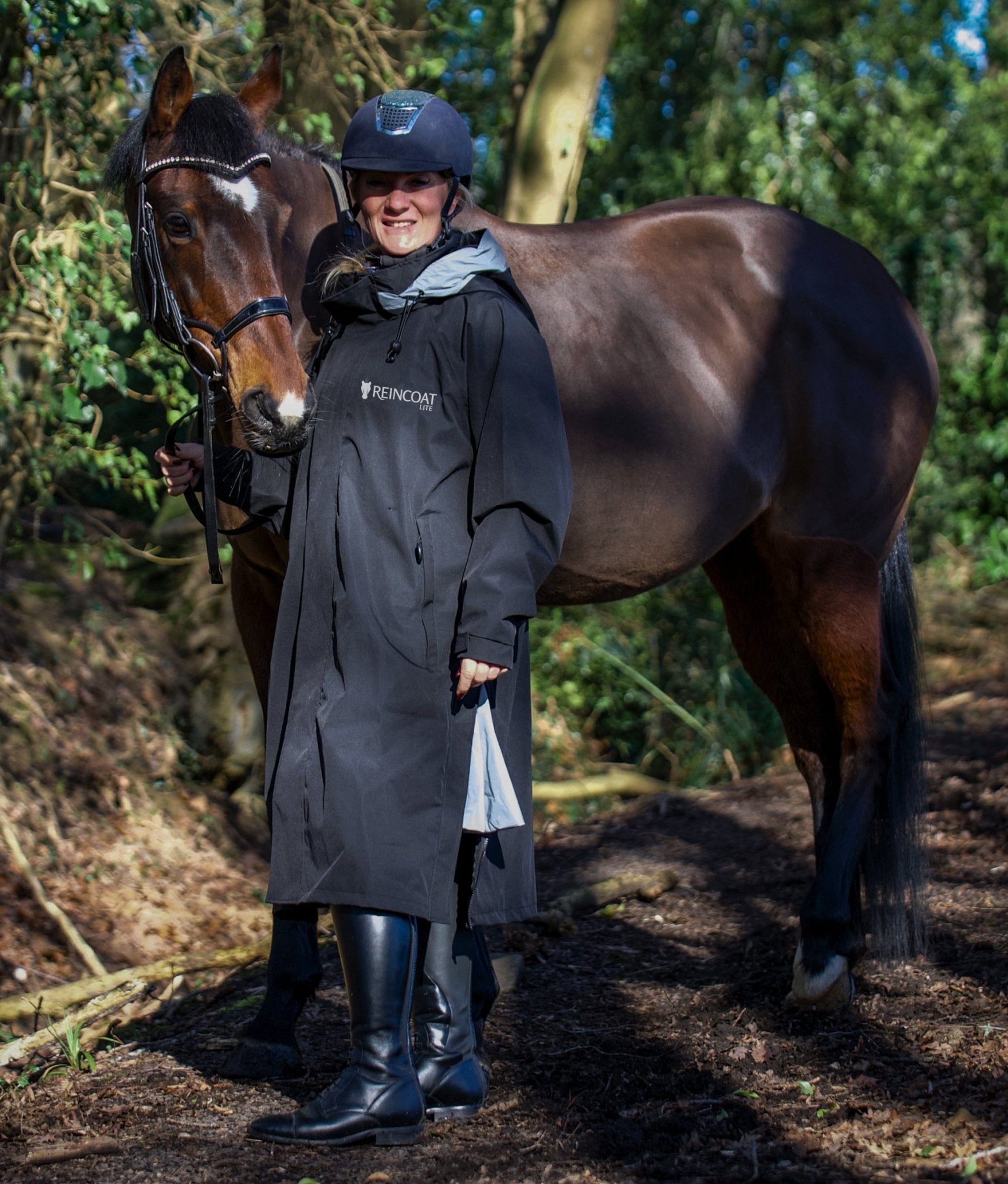 Equestrian Raincoat: Woman & Horse in Equiflair REINCOAT LITE Waterproof Riding Coat - Black