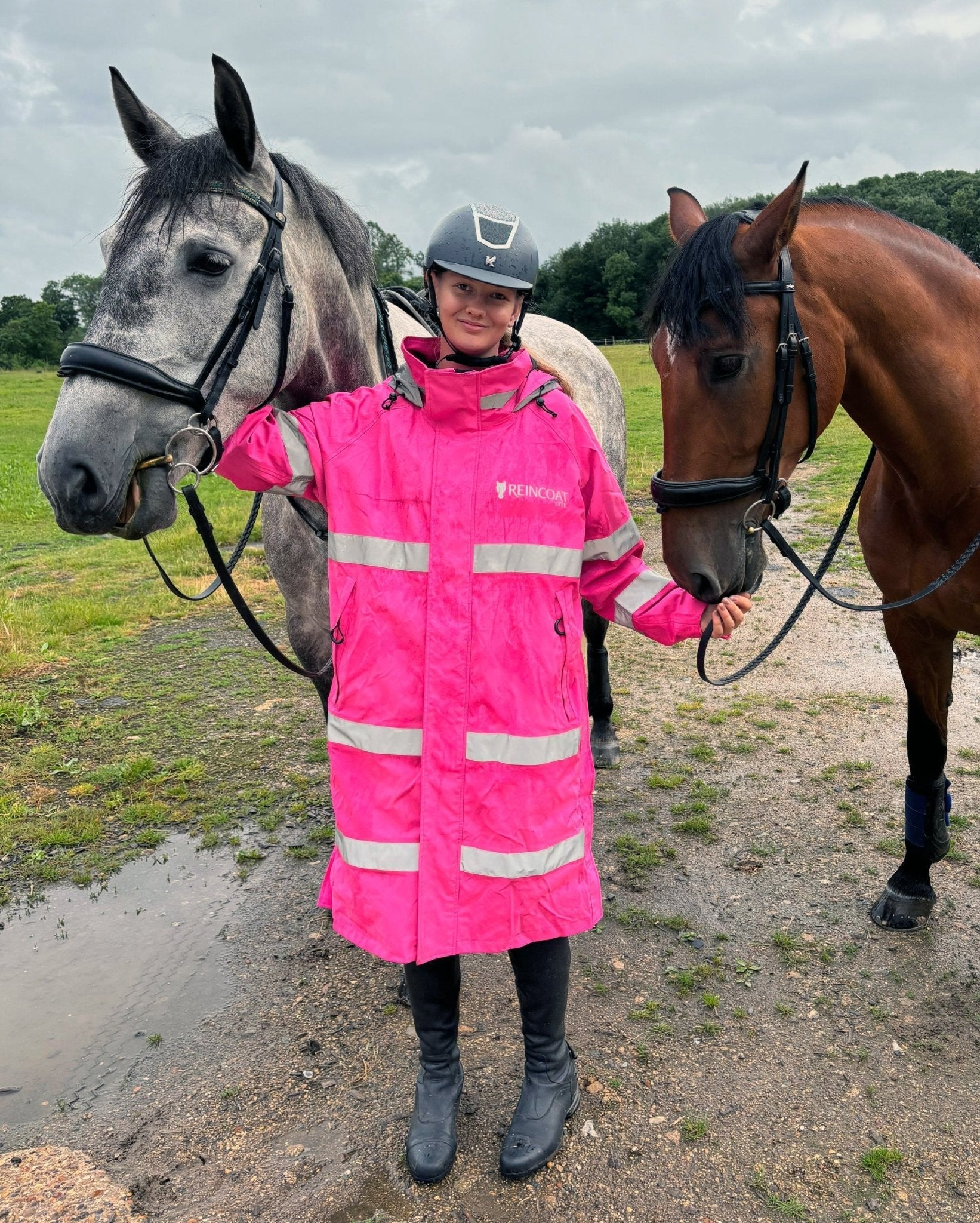 Woman with Horses in REINCOAT LITE Pink Hi-Vis Rain Jacket. Horse Riding Apparel