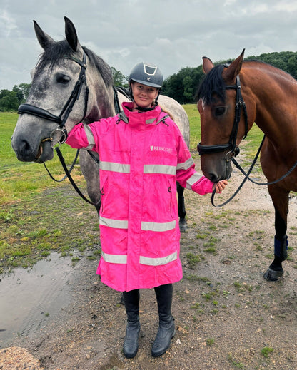 Woman with Horses in REINCOAT LITE Pink Hi-Vis Rain Jacket. Horse Riding Apparel