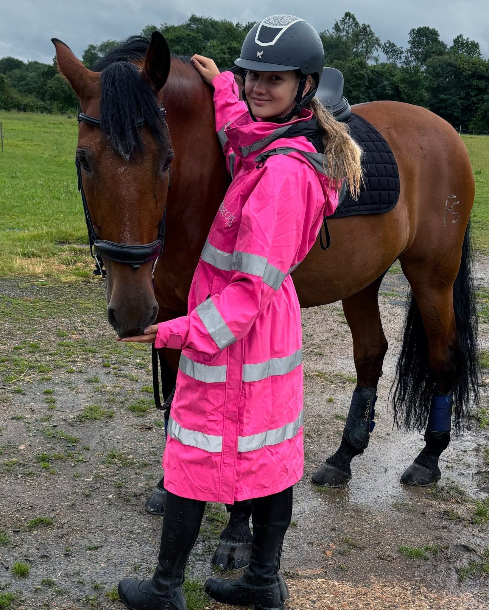 Horse Rider in Equiflair Hi-Vis Pink Riding Jacket with Horse. Equestrian Safety Gear - Reincoat Lite Adult from Equiflair