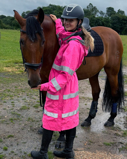 Horse Rider in Equiflair Hi-Vis Pink Riding Jacket with Horse. Equestrian Safety Gear - Reincoat Lite Adult from Equiflair
