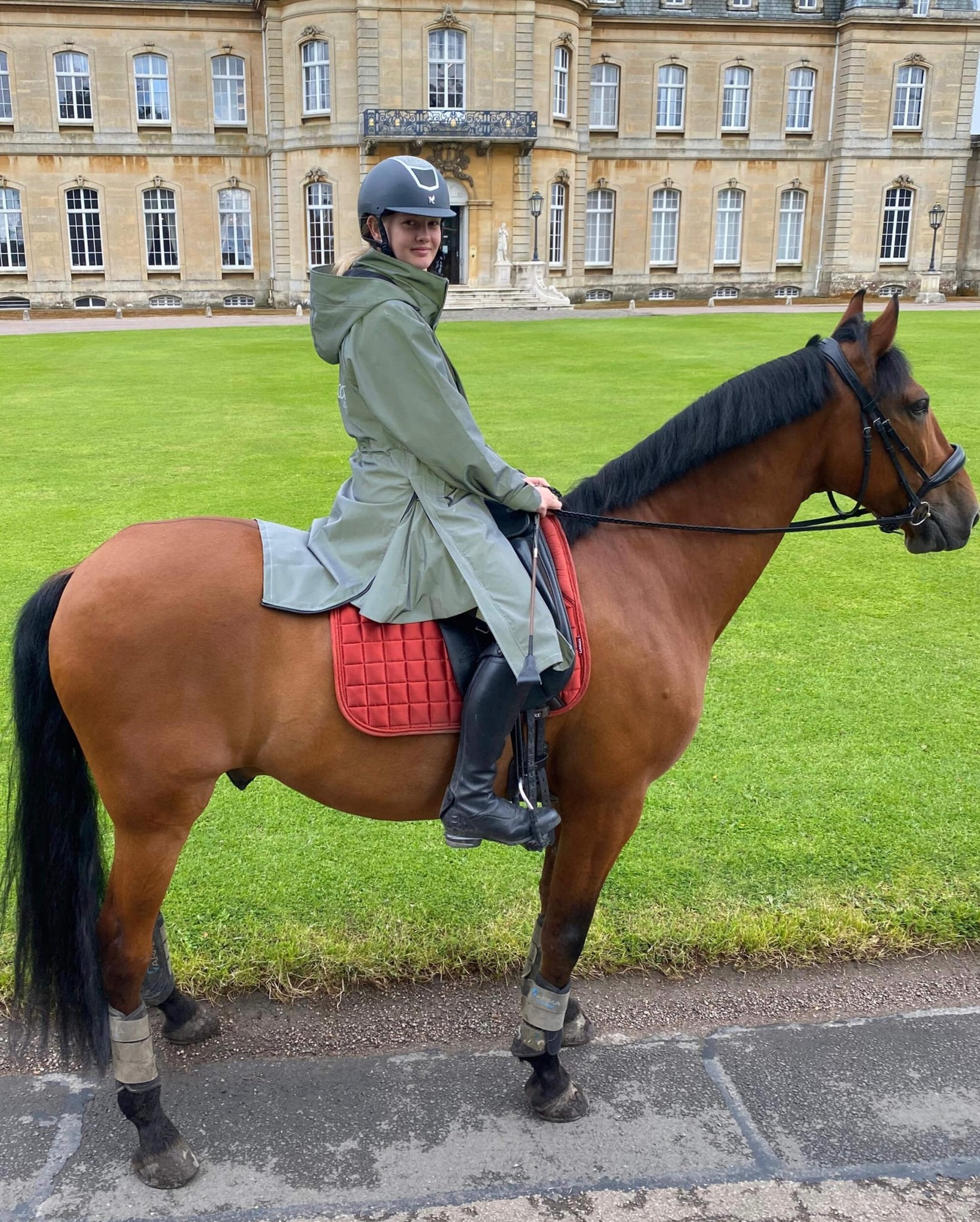 Equiflair Reincoat Lite Kids - Reflective Silver: Girl horse riding, wearing waterproof riding raincoat. Riding safely with reflective gear!