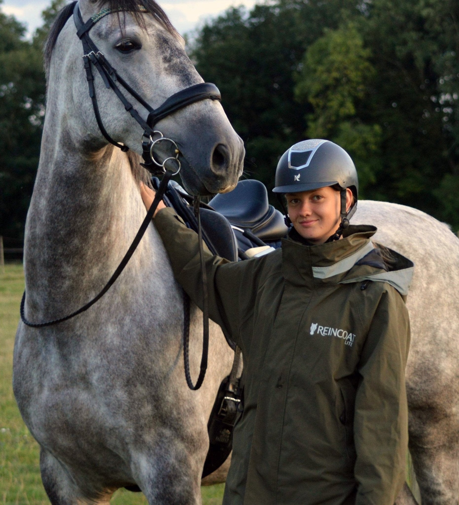 Equestrian Rider in Olive Green Reincoat Jacket with Horse. Waterproof Riding Coat for Women, Reflective, Equiflair.