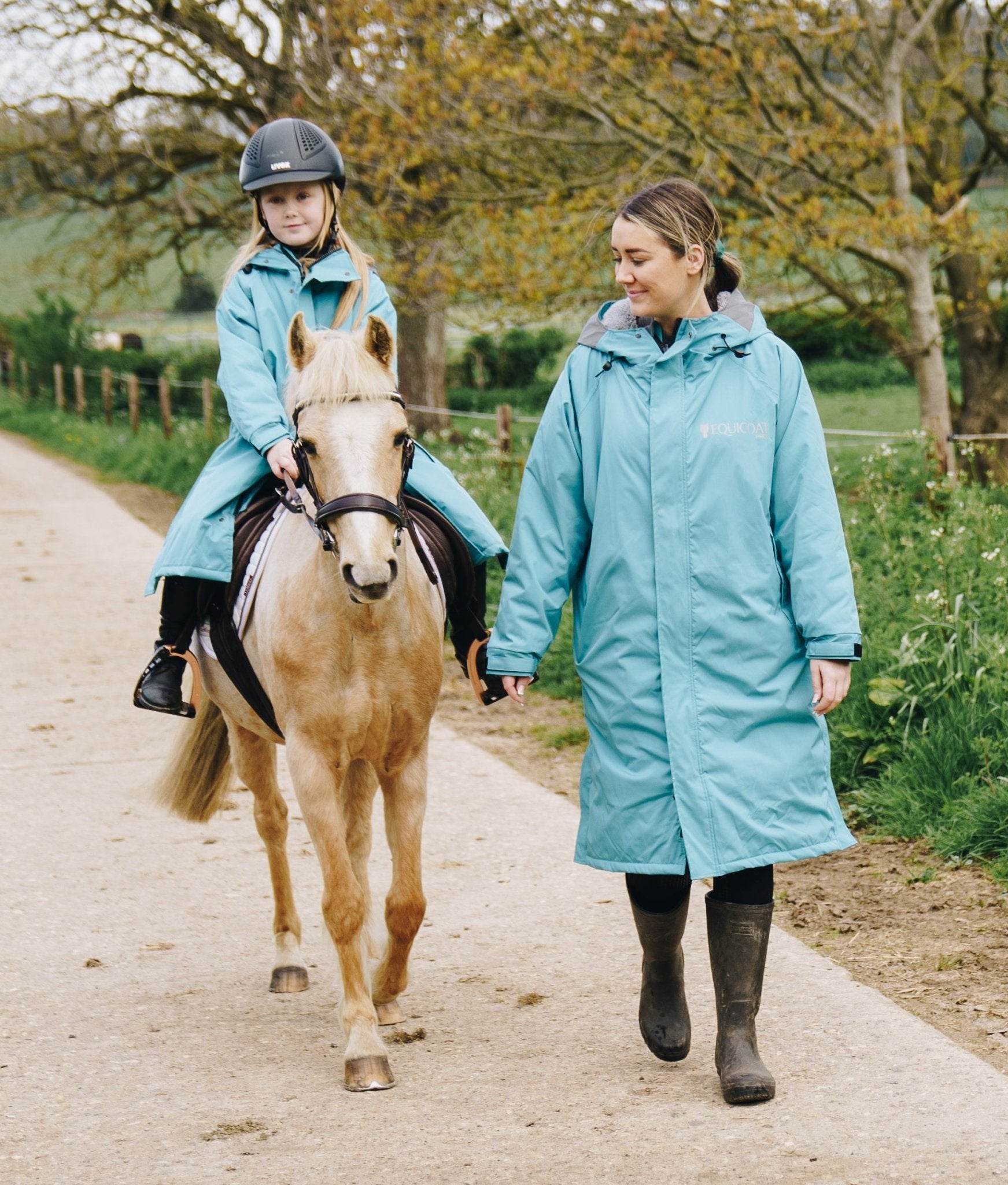 Equicoat Pro Kids Teal Rain Coat for Horse Riding - Girl and Woman Riding Together