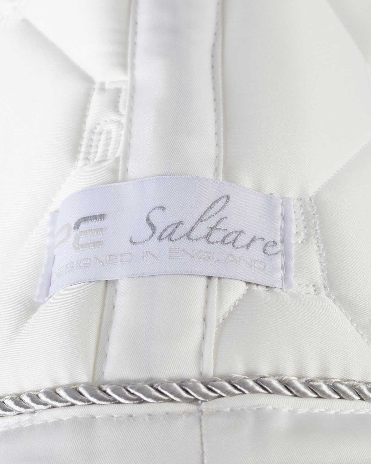 Saltare White Dressage Saddle Pad by Premier Equine. Close Contact, elegant design for superior comfort and performance.
