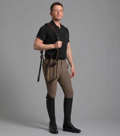 Premier Equine Men's Riding Breeches: Equestrian apparel, horse riding fashion, black boots, and stylish riding attire.