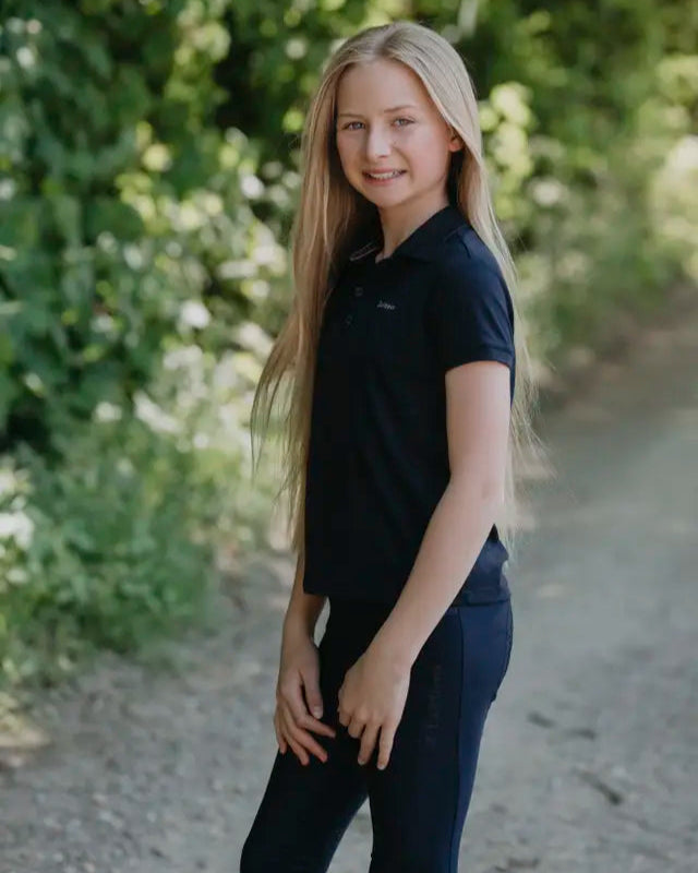 Girl in LeMieux Junior Pro Polo Shirt Navy: Equestrian Apparel for Young Riders