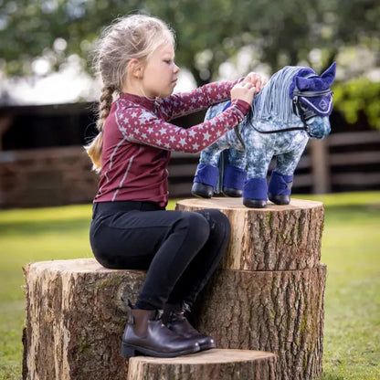 Girl plays with LeMieux toy horse bridle (black). Pretend tacking up with metal bit & reins for equestrian fun!