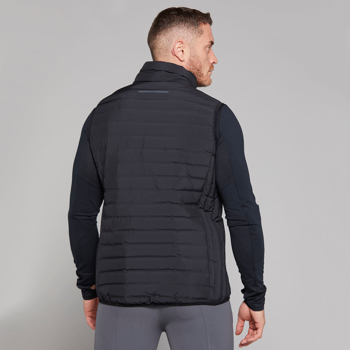 Back view of man wearing TOGGI MEN'S MINI LOFTY DOWN FILL GILET in black - Equiflair