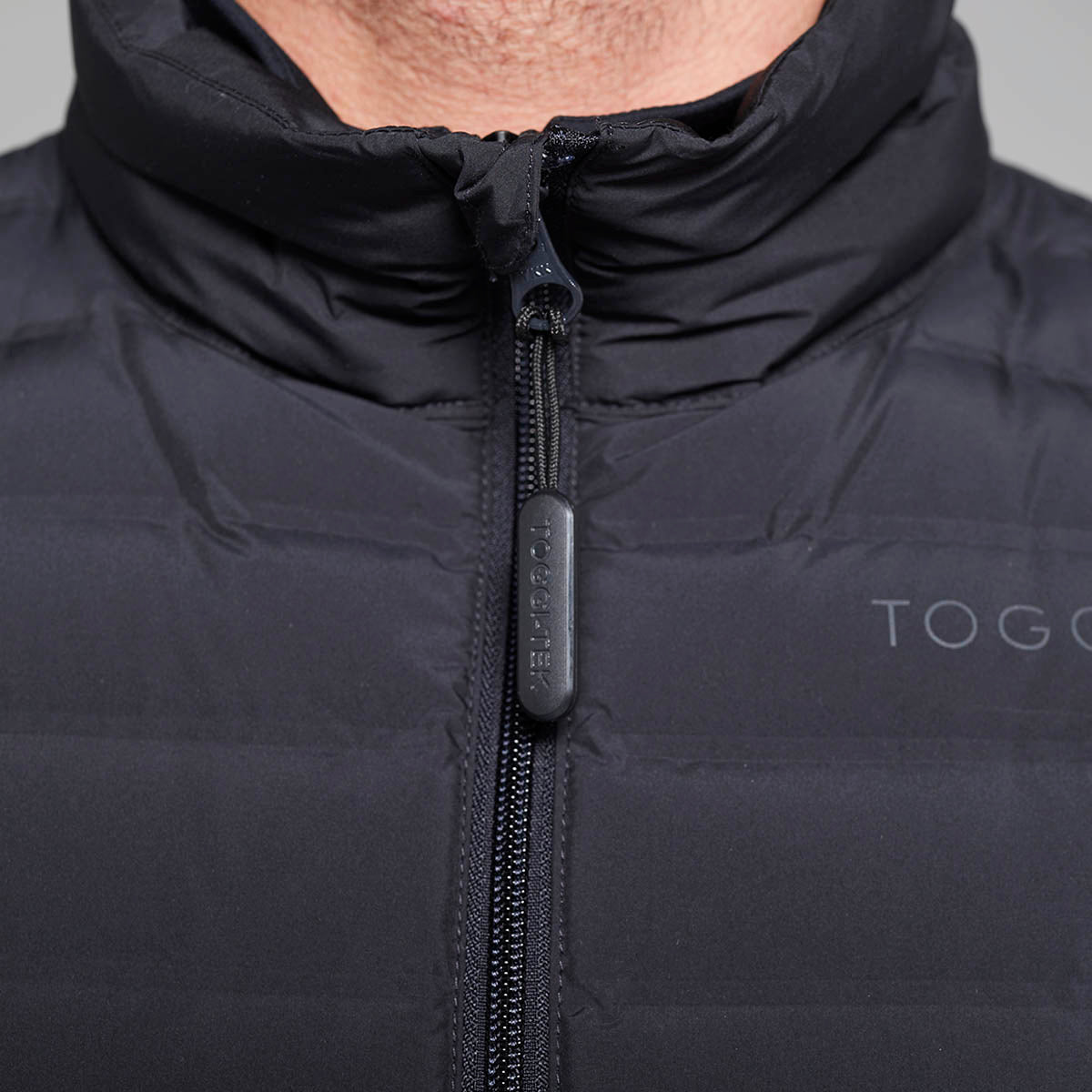 TOGGI MEN'S MINI LOFTY DOWN FILL GILET close-up of zipper with TOGGI-TEK pull and logo.