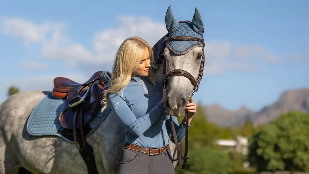 LeMieux Ice Blue Fly Hood on Horse with Blonde Equestrian Rider | Equiflair