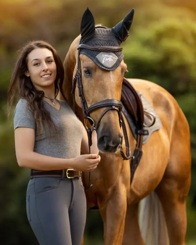 Equestrian Beauty: Woman and Horse Wearing Lemieux Earth Fly Hood in Moss Green from Equiflair - Sustainable Horse Riding Gear