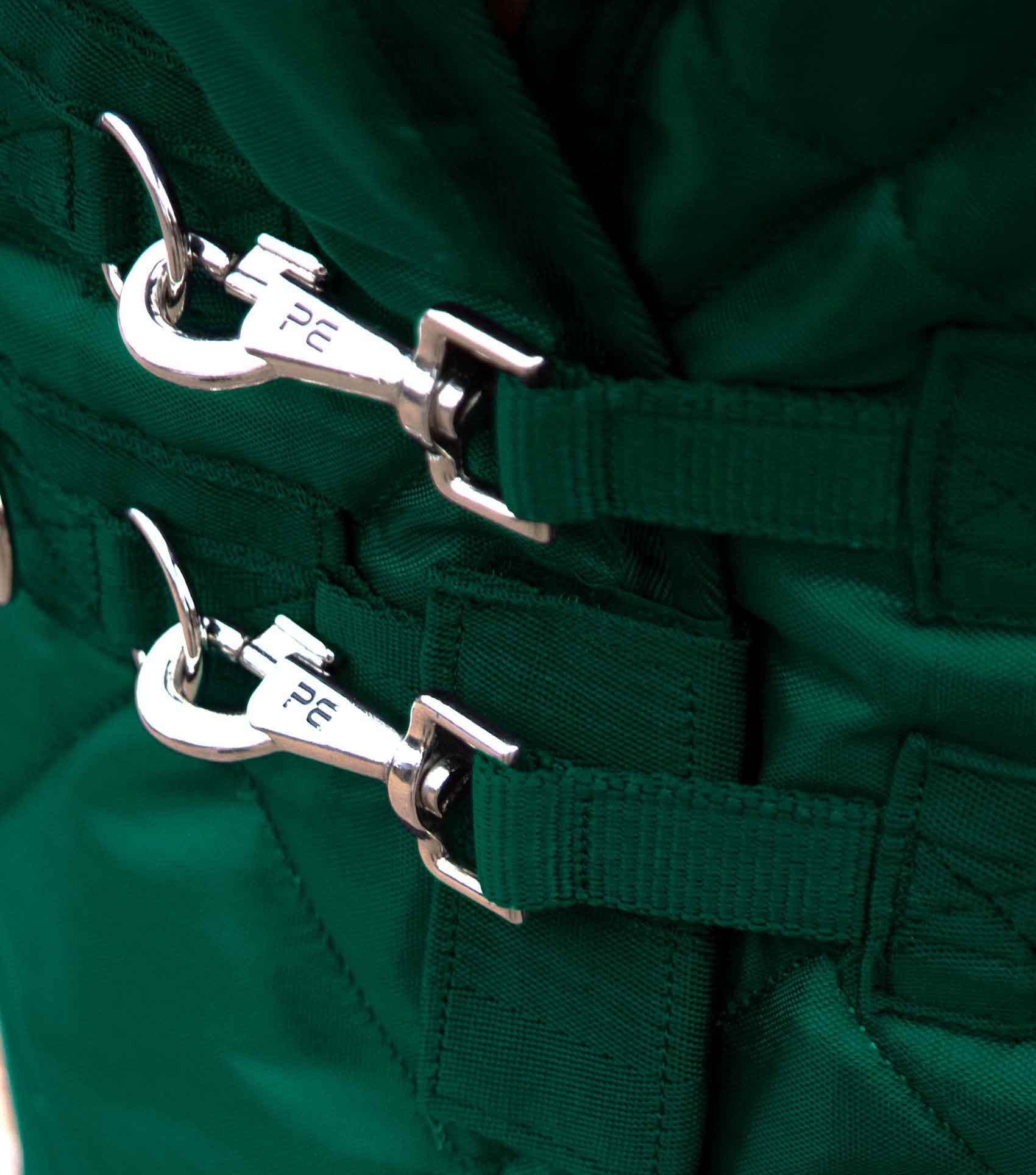 Close up of Premier Equine Tuscan 200g Horse Stable Rug in Green with Stainless Steel Clips