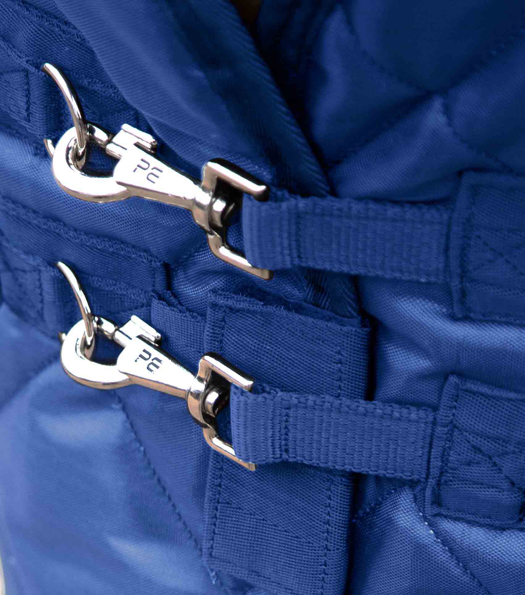 Premier Equine Stable Rug: Close-up of blue horse rug buckles.